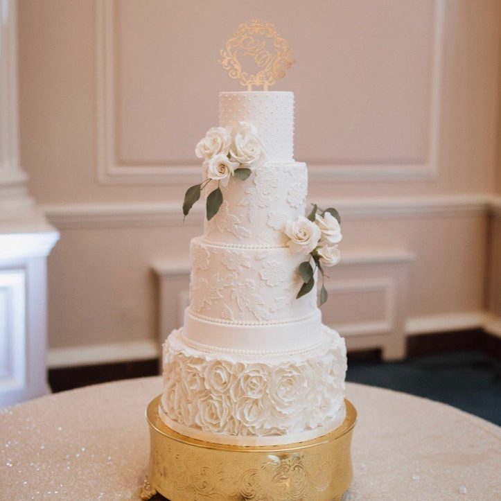 White and green tiered custom cake with cascading sugar flowers ...