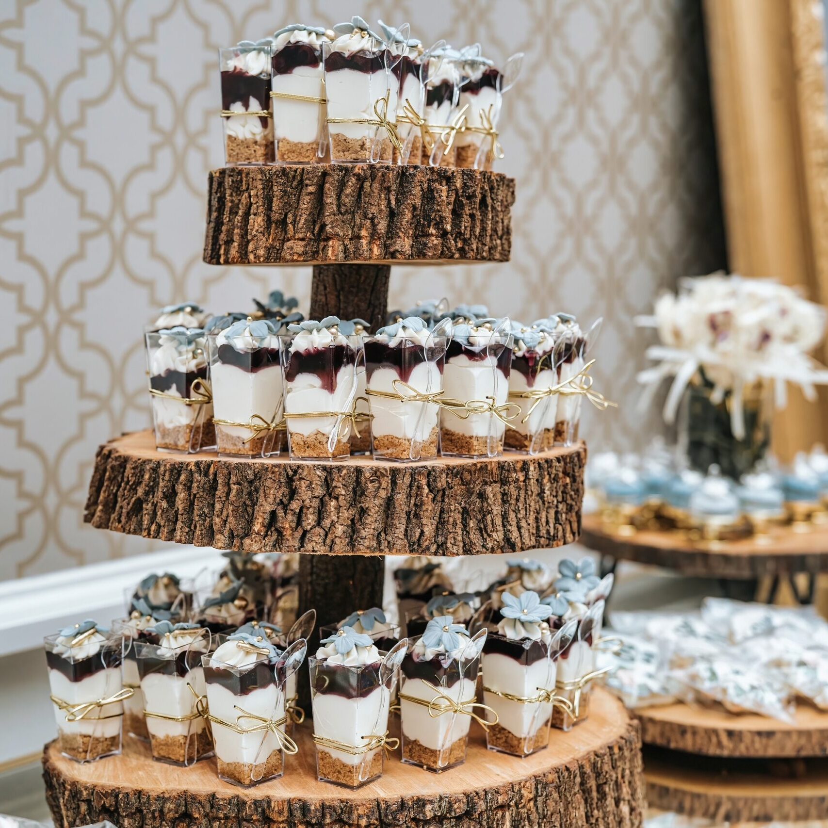 Cherry cherry cheese cake tumblers on a wooden tower, dusty blue accents.