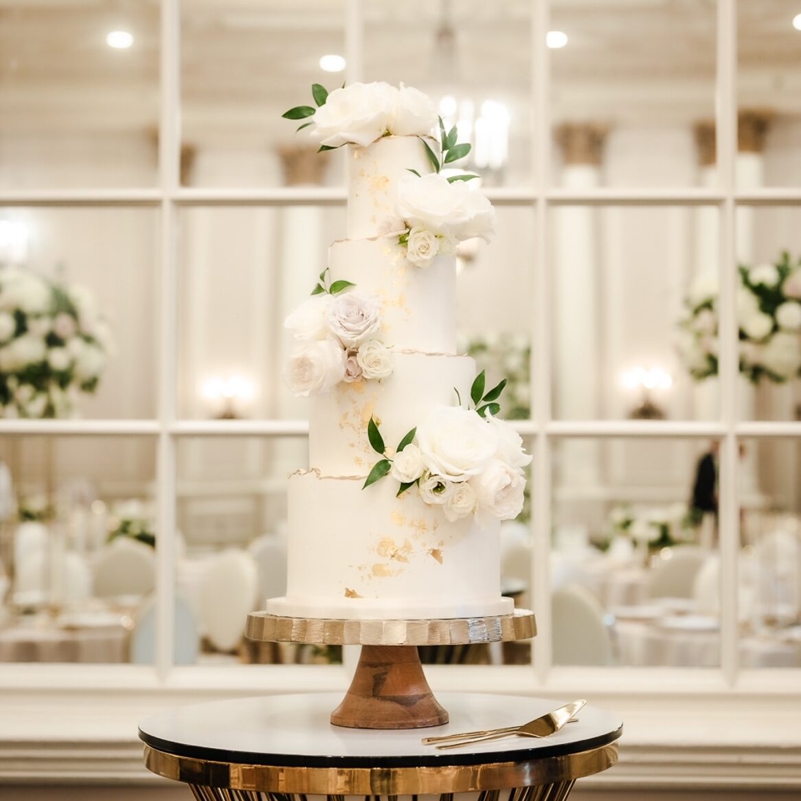 White and green tiered custom cake with cascading sugar flowers ...